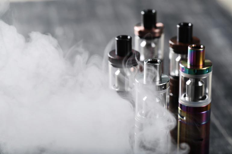 vape in social setting, people vaping at festival, sleek disposable vape, conversation starter vape - The Advantages of Disposable Vapes for Social Vaping Occasions ...