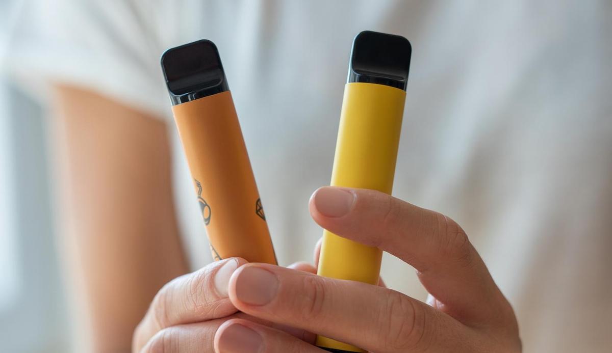 Vaper on Great Ocean Road, person holding disposable vape Australia scenic, vape travel Australia - Vape alert: Parents at Ocean Road Primary School sent text about ...