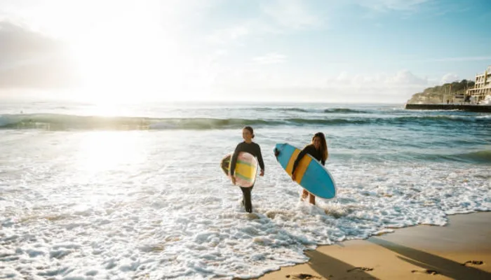 Bondi Beach summer day, person enjoying beach with surfboard and light shorts - Things to Do in Bondi Beach