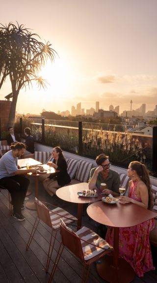 rooftop bar Sydney sunset with elegant vape, people socializing with sleek disposable vape - 22 of the best rooftop bars in Sydney | Sydney.com